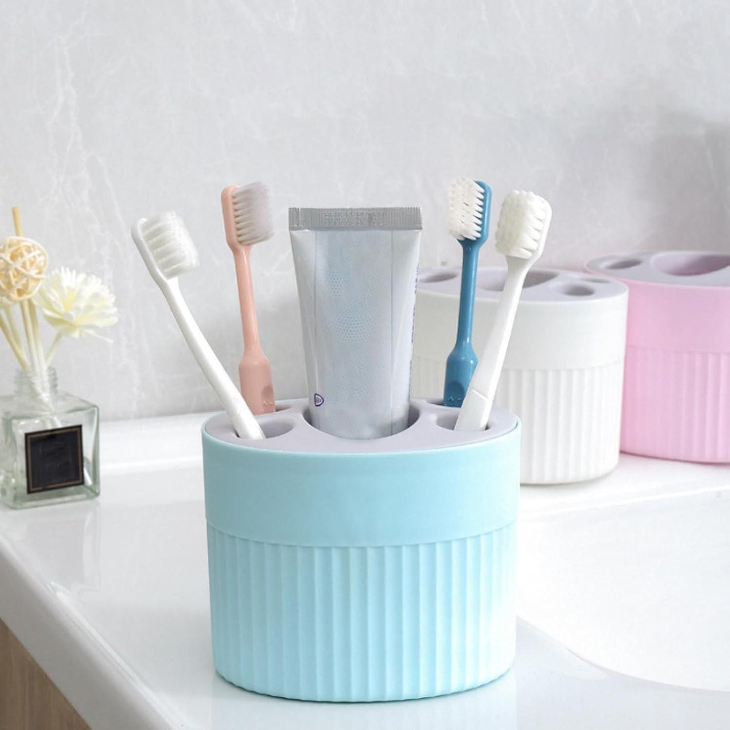 THE GIR FARMER plastic-free storage container holding toothbrushes and toothpaste on bathroom counter