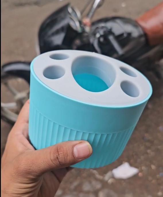 THE GIR FARMER blue plastic-free storage container with multiple compartments held in hand
