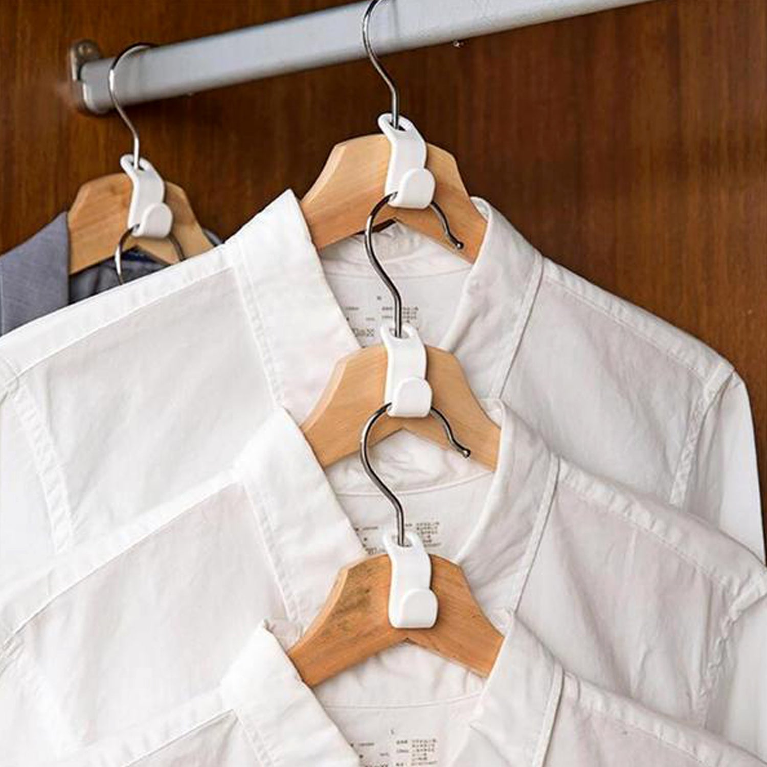 Plastic non-slip clothes hanger holding neatly pressed shirts in a closet for organized storage