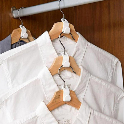 Plastic non-slip clothes hanger holding neatly pressed shirts in a closet for organized storage