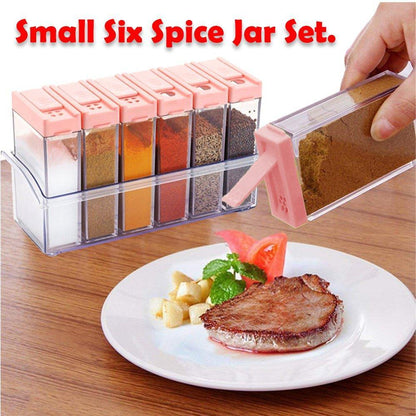 Plastic spice jars set with six small jars for organizing various seasonings on a kitchen countertop