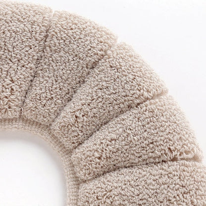 Soft beige plush toilet seat cover made from cozy material for added comfort and warmth