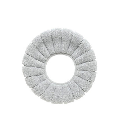 Your Brand plush toilet seat cover in soft gray for added comfort and warmth in bathrooms