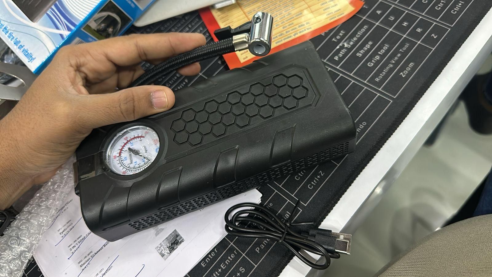Handheld portable air compressor tire inflator with digital gauge and USB charging cable