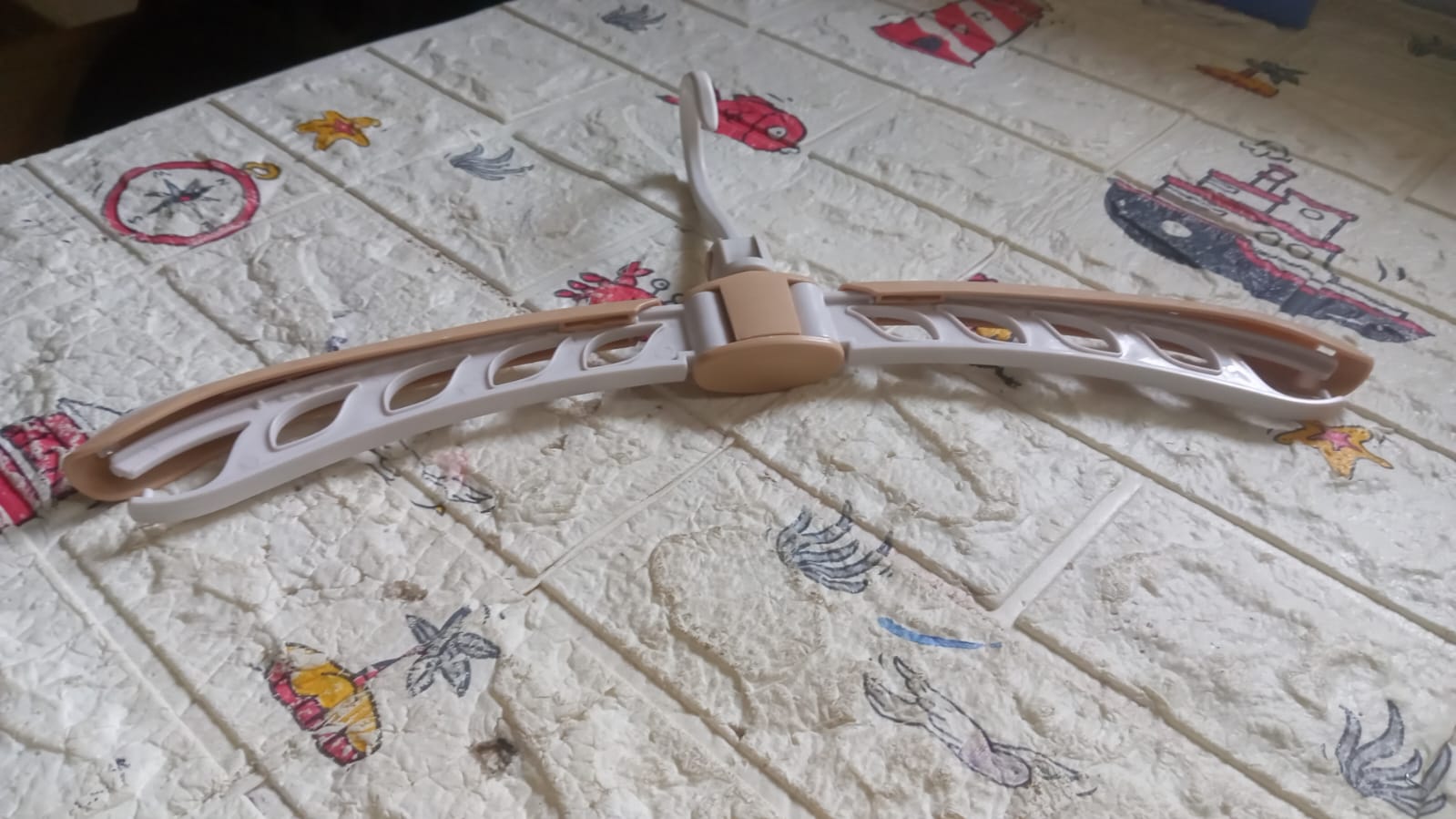 Your Brand portable folding clothes hanger in beige and white for easy laundry organization