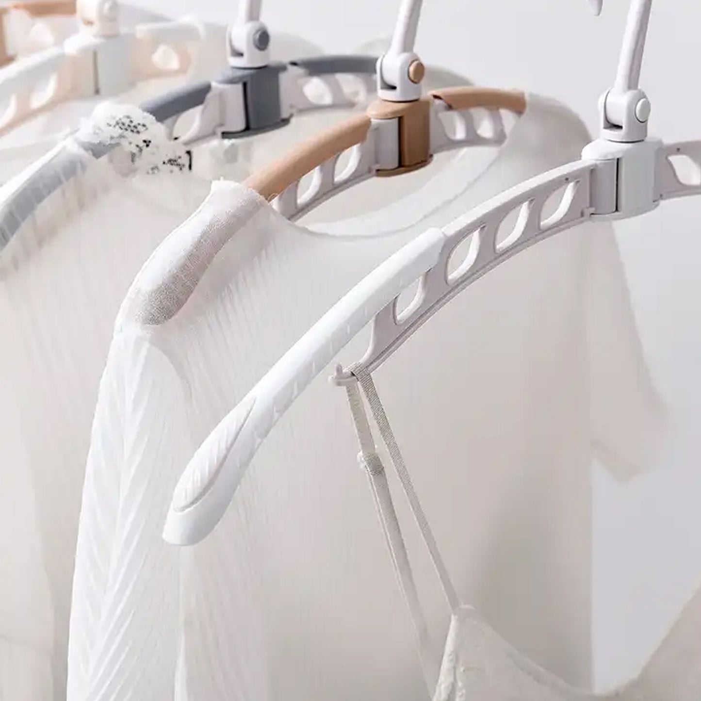 Portable folding clothes hanger displaying various garments for efficient drying and storage