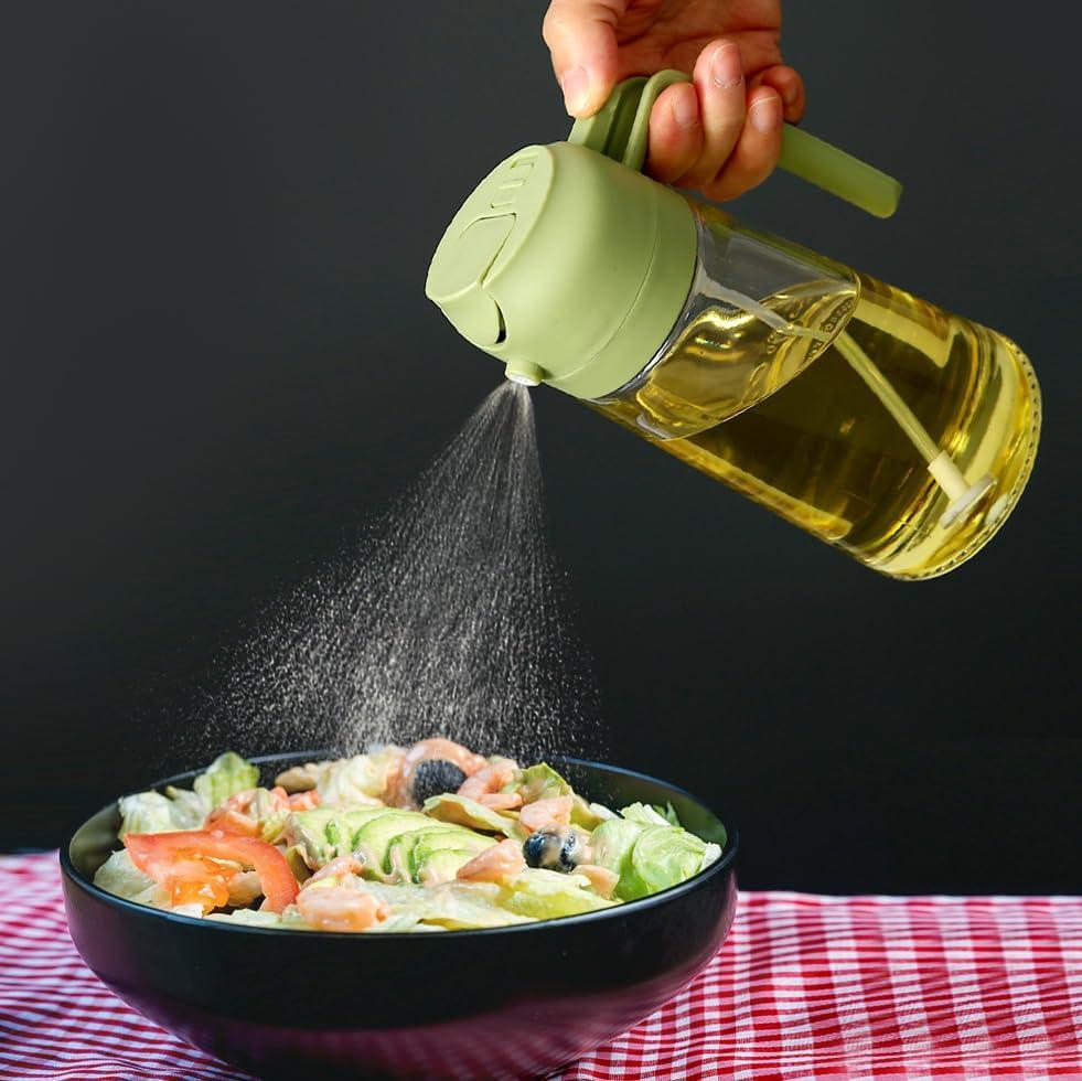 Handheld portable oil sprayer dispenser spraying oil onto a fresh salad in a black bowl