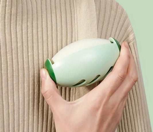 Portable silicone lint roller in hand, perfect for removing lint and pet hair on the go
