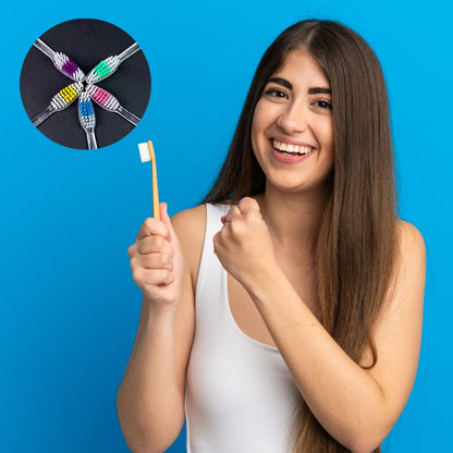 Happy woman holding a premium plastic toothbrush with colorful bristles against a blue background