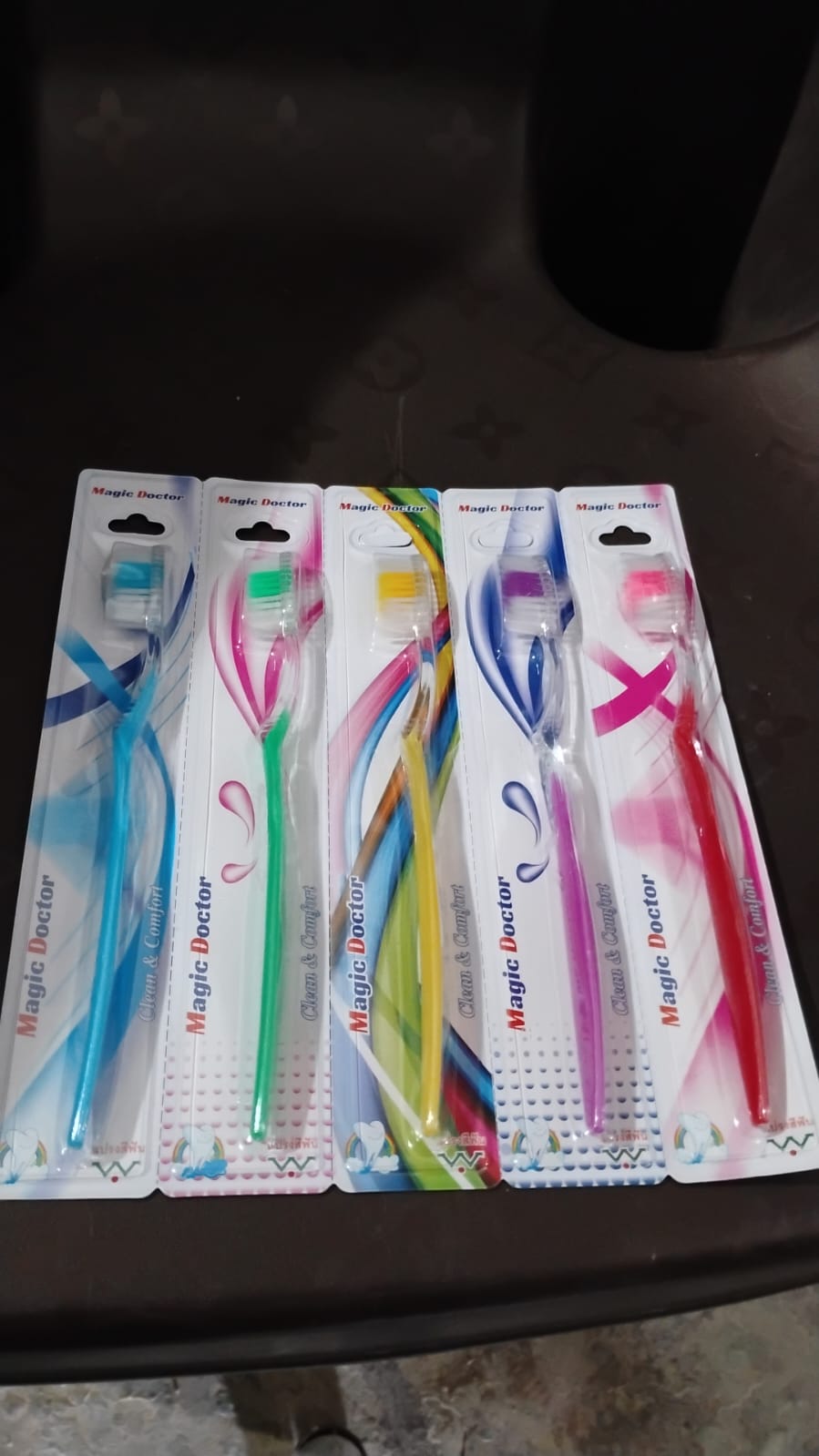 Set of colorful premium plastic toothbrushes in packaging for effective oral care