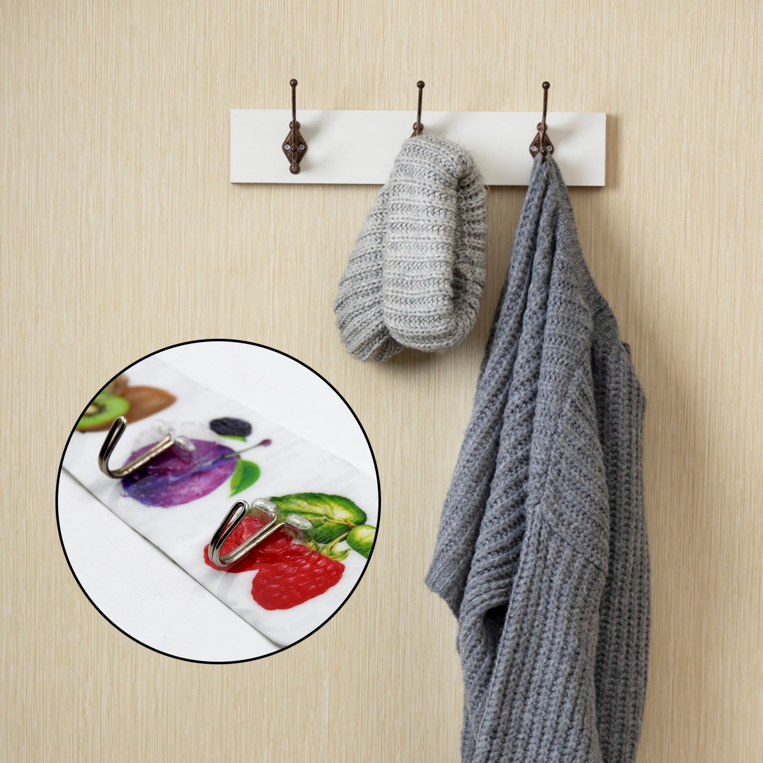 Premium transparent adhesive wall hooks securely holding a cozy sweater and mittens on a wall rack.