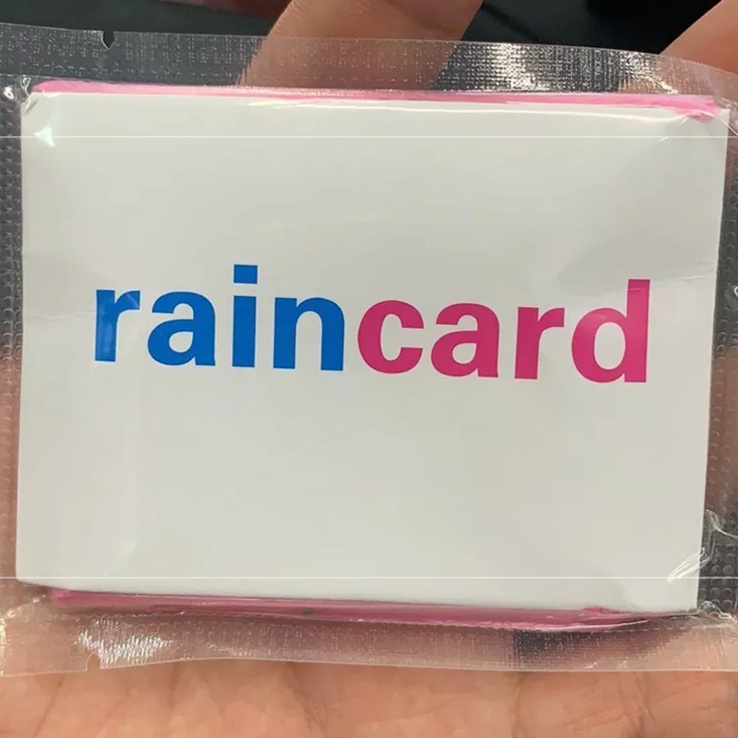 Your Brand waterproof rain coat pouch packaged in a clear plastic wrapper for outdoor protection