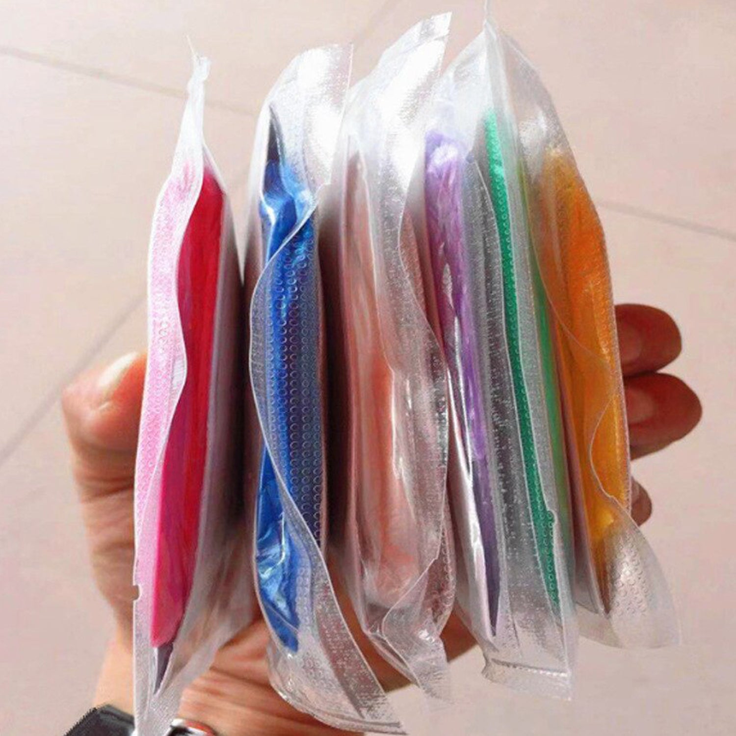Colorful waterproof rain coat pouches neatly organized for convenient storage and easy access