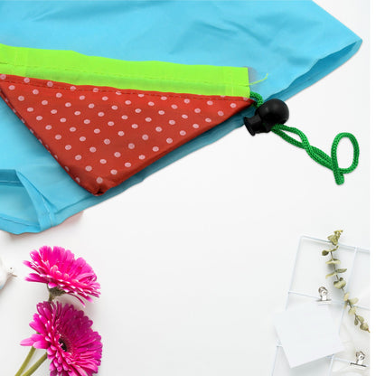 Compact reusable grocery bag with handles in blue and green, featuring a chic polka dot design