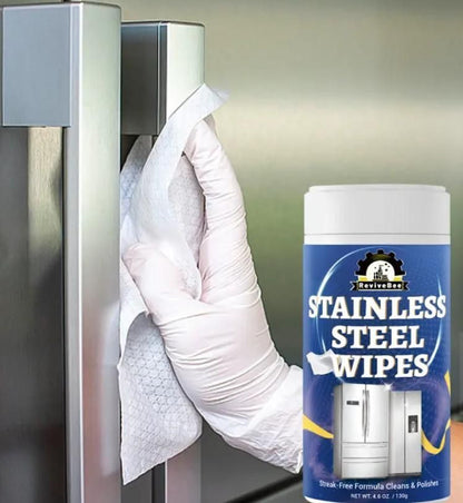 Hand using stainless steel wipes for fridge and appliances to clean stainless steel refrigerator handle