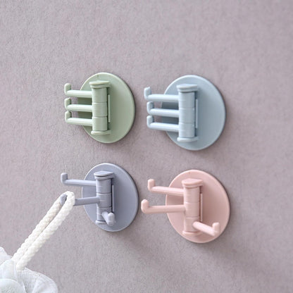 Set of four rotating sticky wall hooks in pastel colors for easy wall organization