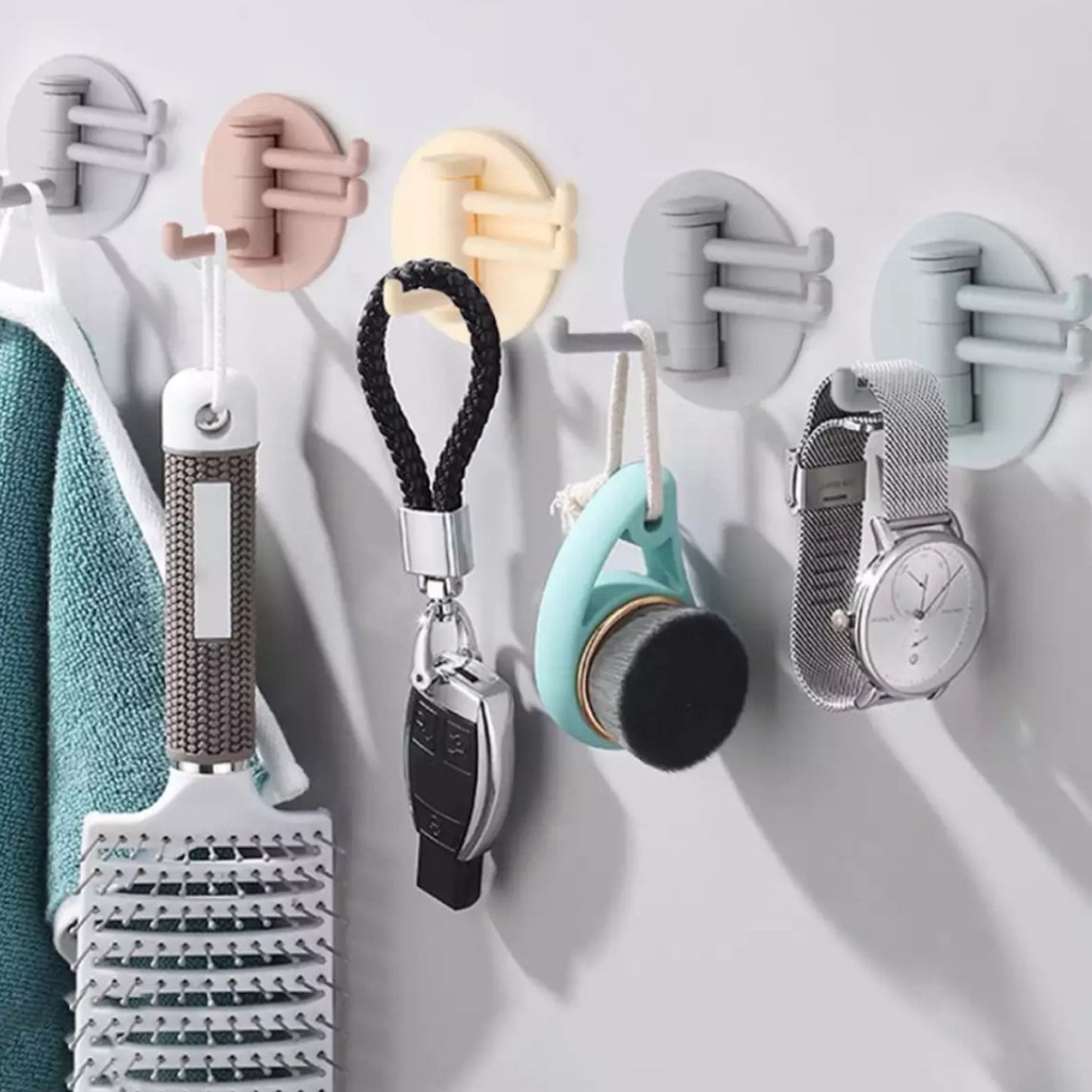 Rotating sticky wall hook set in various colors for organizing household items and accessories