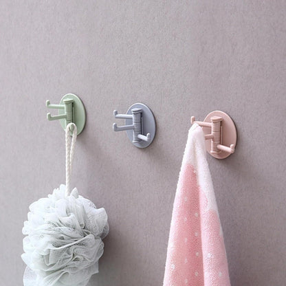 Set of three rotating sticky wall hooks in pastel colors for convenient hanging and organization