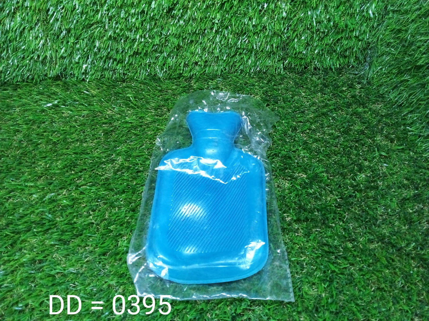 Blue rubber hot water bag for pain relief in packaging, ideal for soothing aches and cramps