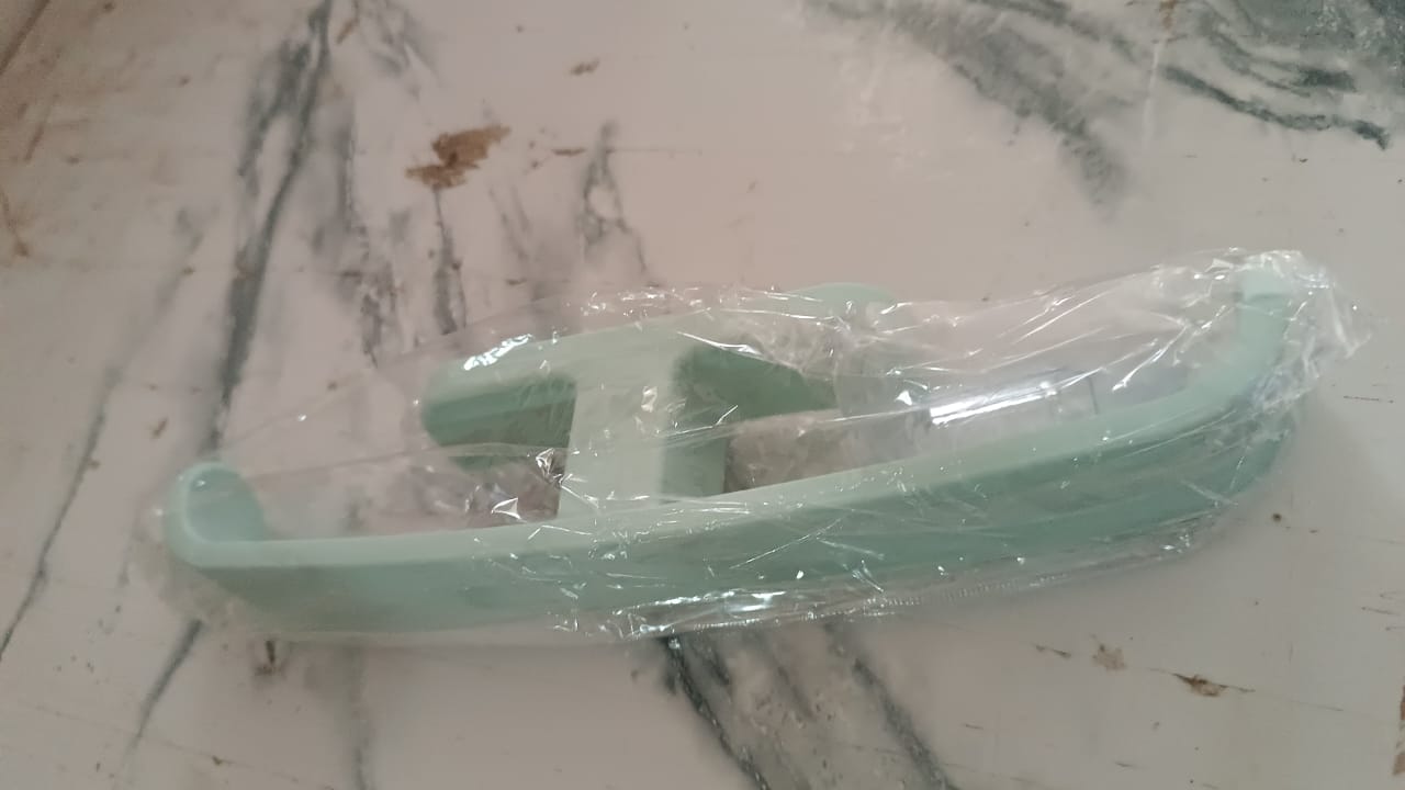 Self adhesive bathroom towel rack in mint green packaging for easy installation