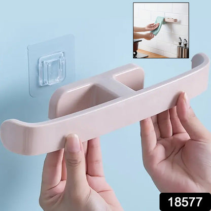 Self adhesive bathroom towel rack being installed on a bathroom wall for convenient towel storage