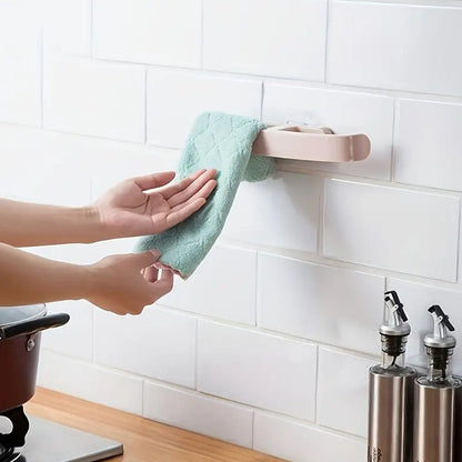 Self adhesive bathroom towel rack mounted on a wall with a soft towel hanging from it