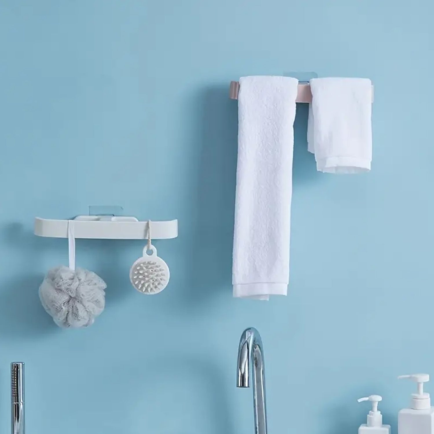 Self adhesive bathroom towel rack holding two white towels for easy access and organization