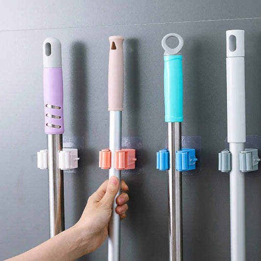 Self adhesive mop holder with multiple hooks for organizing cleaning tools on a wall