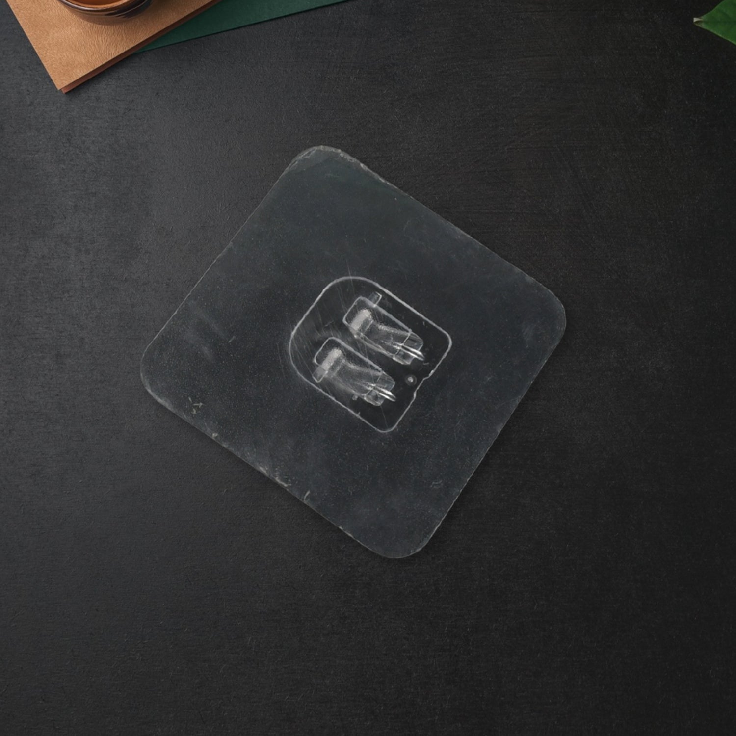 Self adhesive wall hooks in clear plastic for easy installation and organization