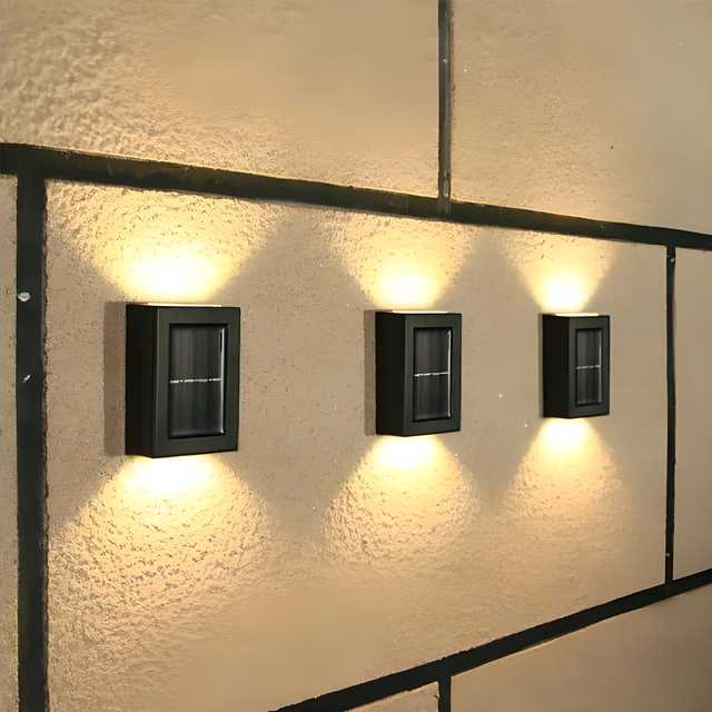 The Gir Farmer outdoor solar lighting for home with three black wall-mounted rectangular lights illuminating textured exterior wall