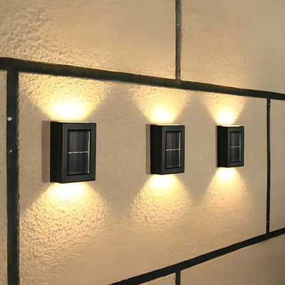 The Gir Farmer outdoor solar lighting for home with three black wall-mounted rectangular lights illuminating textured exterior wall