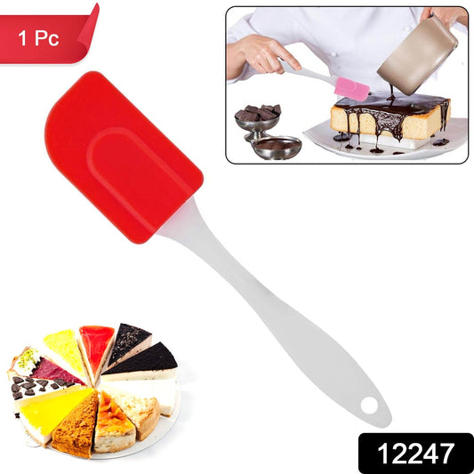 Red silicone baking spatula with a white handle ideal for mixing and spreading batter in the kitchen