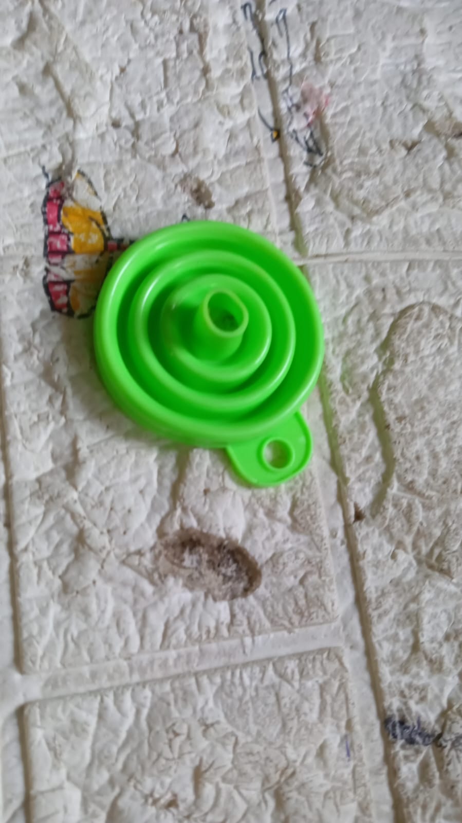Bright green silicone kitchen funnel designed for easy pouring and storage in your home kitchen
