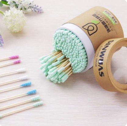Soft wood stick cotton swabs with light green tips in a round brown container from The Gir Farmer