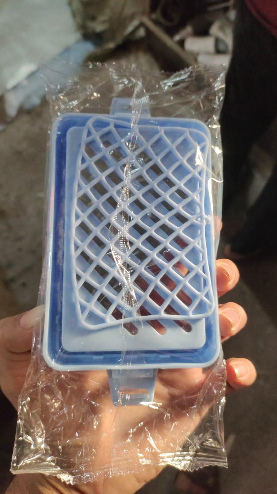Blue soap mesh holder with a grid design for keeping soap organized and drying quickly