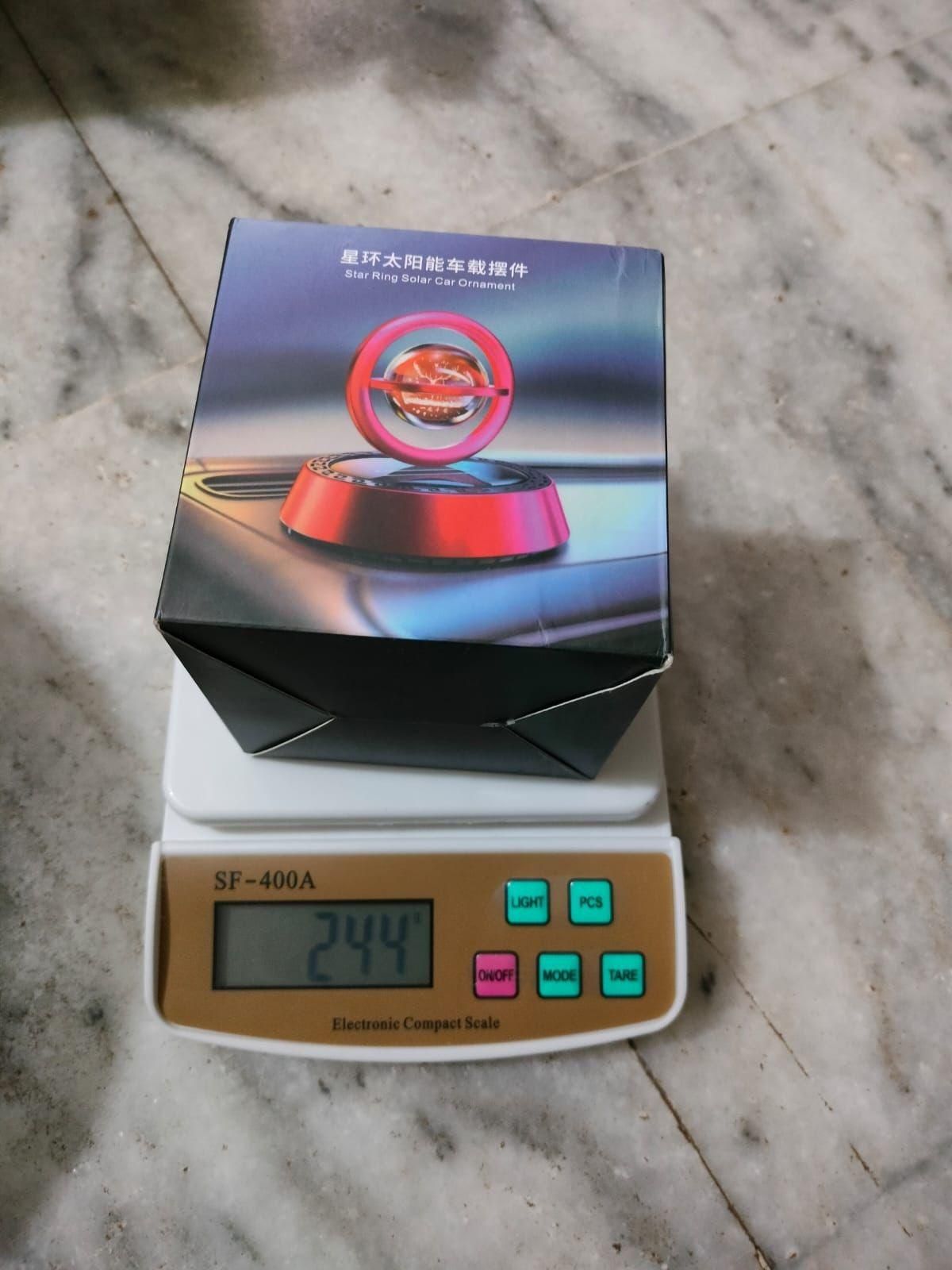 Solar car perfume diffuser packaging displayed on a digital scale for easy transport and use