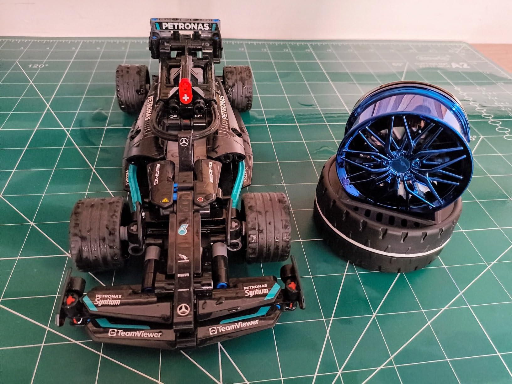 Detailed model of a racing car with a blue wheel next to it, featuring a solar powered car air freshener