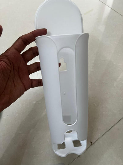White plastic space saving wall storage holder mounted on a beige wall for organizing small items