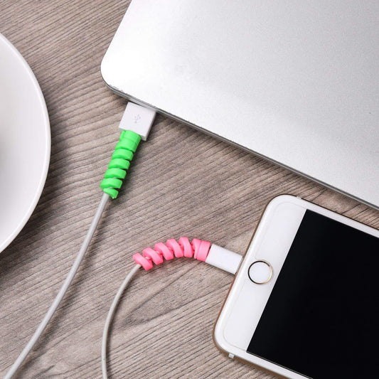 Spiral charger cable protector in green and pink for preventing frays on charging cables