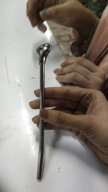 The Gir Farmer stainless steel drinking straws with a reusable bent design held in hand