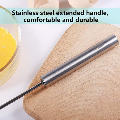 Stainless steel hand blender with extended handle on wooden board near bowl with beaten eggs