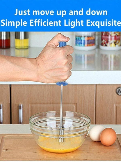Stainless steel hand blender for lassi blending ingredients in a clear bowl on a kitchen counter