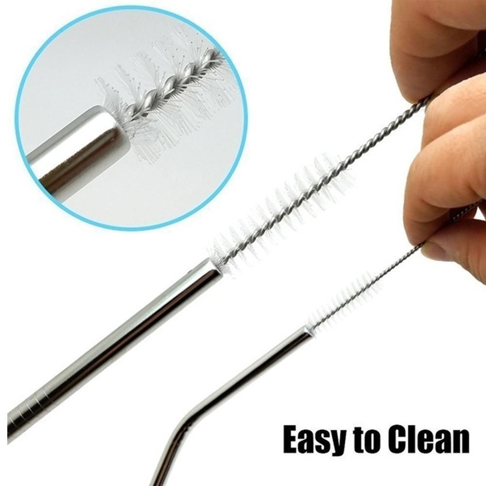 Stainless steel straw cleaning brush held in hand with soft bristles for easy cleaning