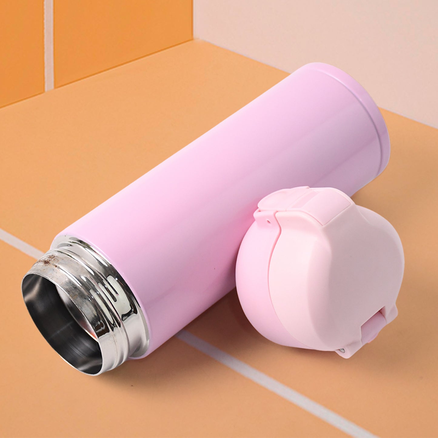 Wukusy stainless steel vacuum water bottle in pink color with a secure cap, perfect for keeping drinks hot or cold