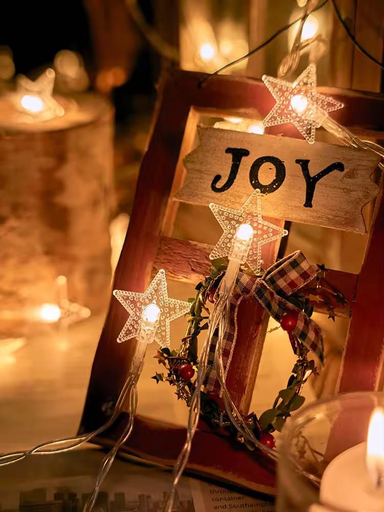 Beautiful star string lights for decoration illuminating a joyful wooden frame and wreath