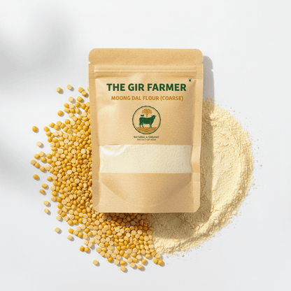 The Gir Farmer Organic Moong Dal Flour in coarse texture with yellow moong dal seeds on a white background