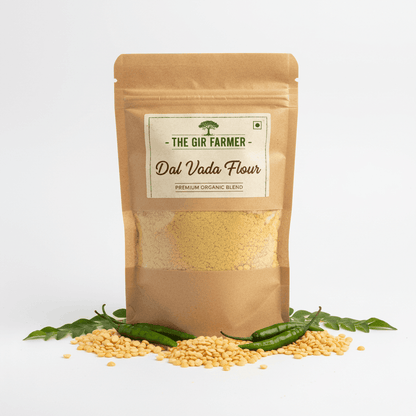 The Gir Farmer Organic Dal Vada Flour in a brown packaging with raw dal and green chilies for making crispy snacks