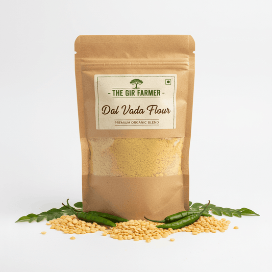 The Gir Farmer Organic Dal Vada Flour in a brown packaging with raw dal and green chilies for making crispy snacks