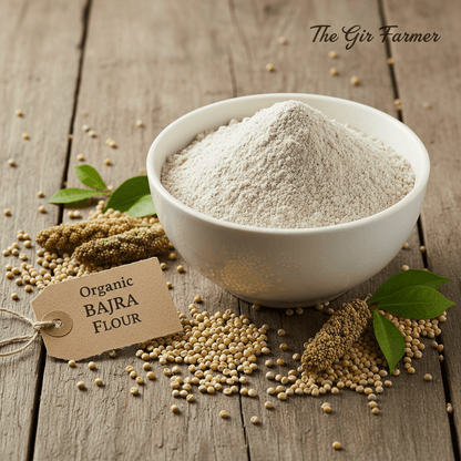 Organic Bajra Flour in a white bowl surrounded by whole grains and green leaves