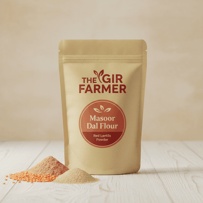 THE GIR FARMER Organic Masoor Dal Flour in a resealable pouch with a vibrant red lentils powder spilled